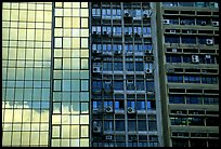 Glass building next to older buildings with air conditioners, Hong-Kong Island. Hong-Kong, China