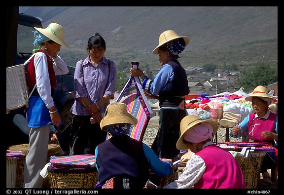 Bai women wearing tribespeople dress at the Monday market. Shaping, Yunnan, China