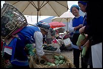 Bai tribeswomen buy vegetables at Monday market. Shaping, Yunnan, China (color)