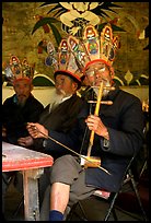 Elderly musician Playing the traditional two-stringed Ehru. Baisha, Yunnan, China (color)