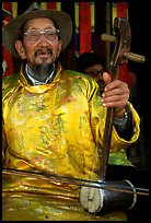 Elderly musician playing the traditional two-stringed Ehru. Baisha, Yunnan, China (color)