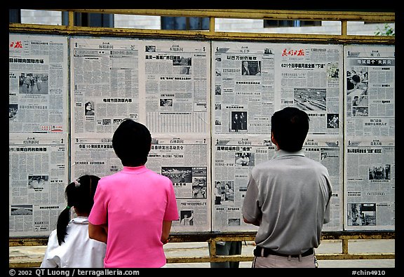 Reading dazibao (public newspapers). Kunming, Yunnan, China