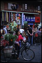 Flower peddler in an old alley. Kunming, Yunnan, China (color)