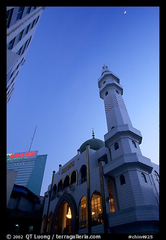 Nancheng Mosque built recently, a hybrid of white-tiled high rise with a mosque's green onion domes. Kunming, Yunnan, China