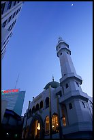 Nancheng Mosque built recently, a hybrid of white-tiled high rise with a mosque's green onion domes. Kunming, Yunnan, China (color)