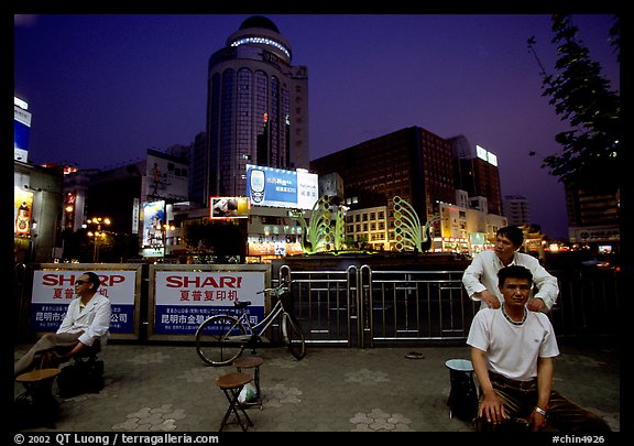 Public massage on the traffic square at  the intersection of Zhengyi Lu and Dongfeng Lu. Kunming, Yunnan, China