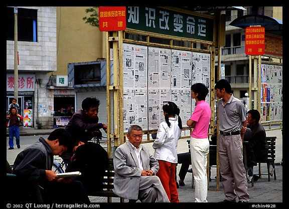 Reading dazibao (public newspapers). Kunming, Yunnan, China