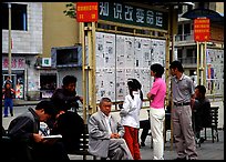 Reading dazibao (public newspapers). Kunming, Yunnan, China