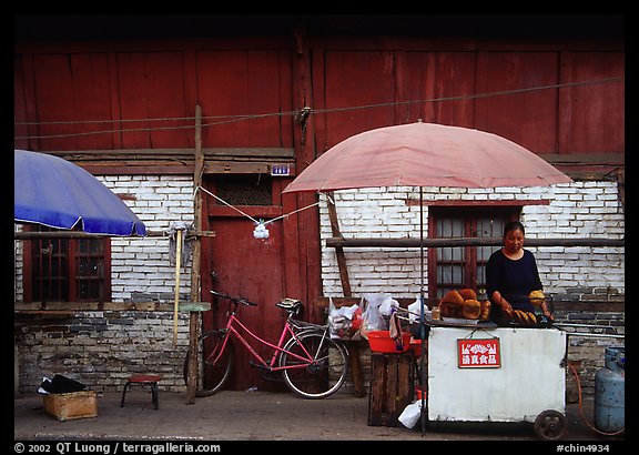 Foot stand in front of a wooden building. Kunming, Yunnan, China (color)