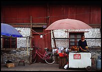 Foot stand in front of a wooden building. Kunming, Yunnan, China ( color)