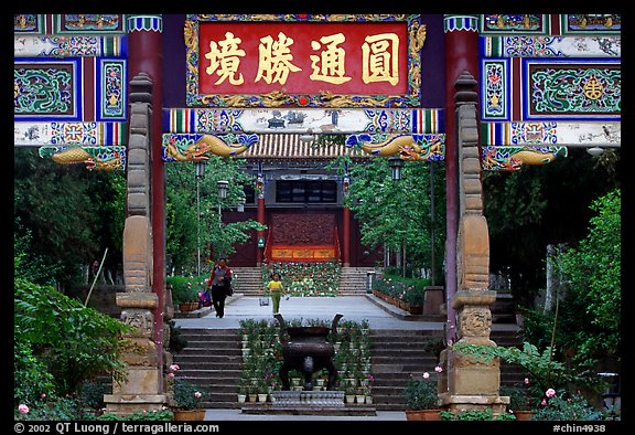 Woman and girl on entrance alley of Yantong Si. Kunming, Yunnan, China