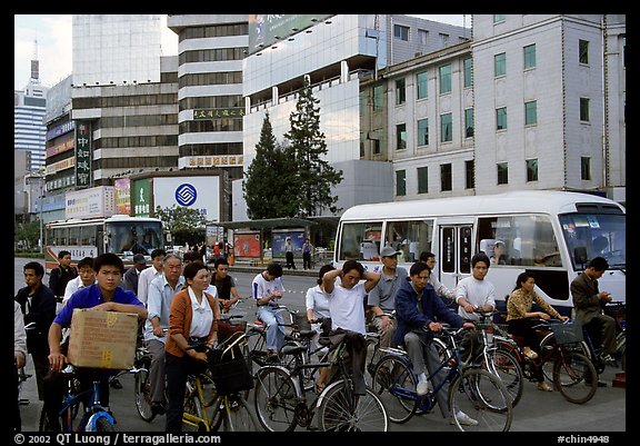 Bicyclists waiting for traffic light. Kunming, Yunnan, China