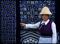 Woman in Bai dress showing drapes of traditional design. Dali, Yunnan, China