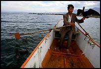 Fisherman holding a cormorant. Dali, Yunnan, China