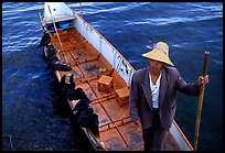 Cormorant Fisherman in a boat with his fishing birds. Dali, Yunnan, China (color)