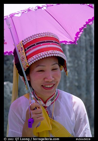 Woman from the Sani branch of the Yi tribespeople with a sun unbrella. Shilin, Yunnan, China