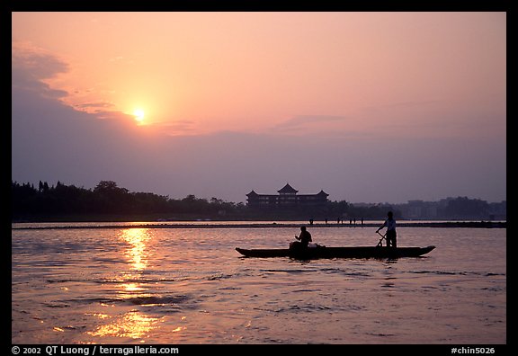 Fishermen at the confluence of the Dadu He and Min He rivers at sunset. Leshan, Sichuan, China