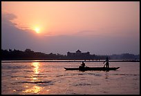 Fishermen at the confluence of the Dadu He and Min He rivers at sunset. Leshan, Sichuan, China (color)