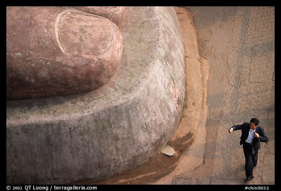 Man standing next to the toe of the Grand Buddha. Leshan, Sichuan, China