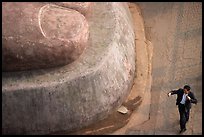 Man standing next to the toe of the Grand Buddha. Leshan, Sichuan, China