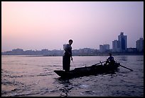 Fishermen at the confluence of the Dadu He and Min He rivers at sunset. Leshan, Sichuan, China (color)