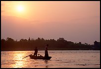 Fishermen at the confluence of the Dadu He and Min He rivers at sunset. Leshan, Sichuan, China ( color)