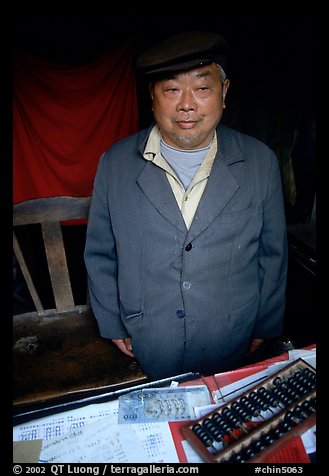 Man in a ticket booth with a counting frame. Leshan, Sichuan, China