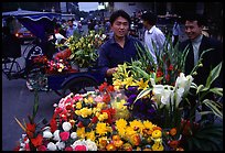 Flower vendor, night market. Leshan, Sichuan, China