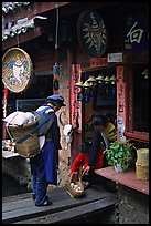 Naxi woman offers eggs for sale to local residents. Lijiang, Yunnan, China