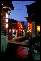 Streets, bridge, wooden houses, red lanterns and canal. Lijiang, Yunnan, China (color)