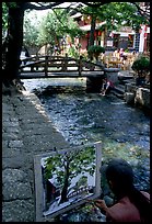 Painting a bridge. Lijiang, Yunnan, China