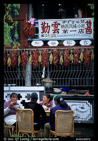 Women eat outside the Snack Food in Lijiang restaurant. Lijiang, Yunnan, China (color)