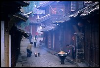 Street in the morning with dumplings being cooked. Lijiang, Yunnan, China