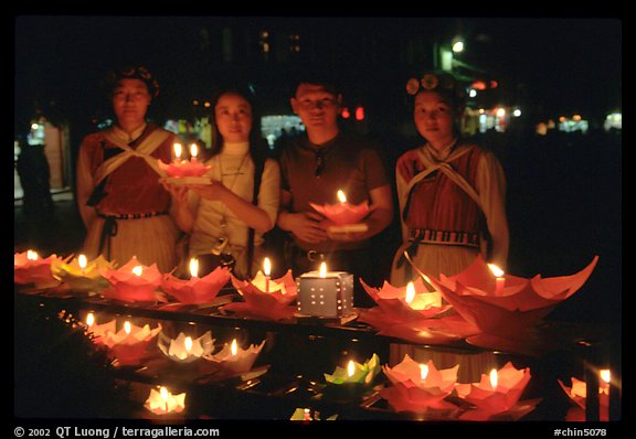 Candlelight lanters to be floated on a canal at night. Lijiang, Yunnan, China (color)