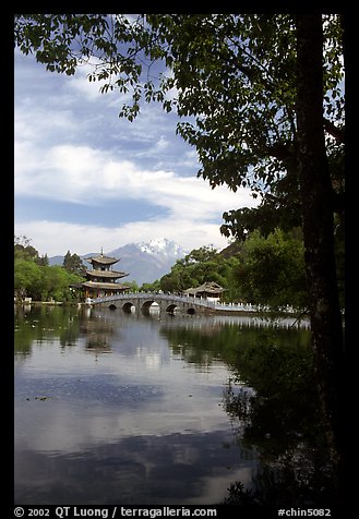 Pavillon reflected in the Black Dragon Pool, with Jade Dragon Snow Mountains in the background. Lijiang, Yunnan, China