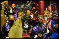 Elderly musicians of the Naxi Orchestra playing traditional instruments. Lijiang, Yunnan, China