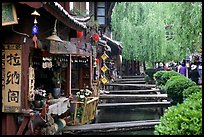 Bridges leading to restaurants and residences across the canal. Lijiang, Yunnan, China