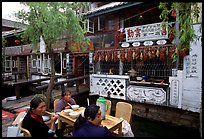 Women eat outside the Snack Food in Lijiang restaurant. Lijiang, Yunnan, China (color)