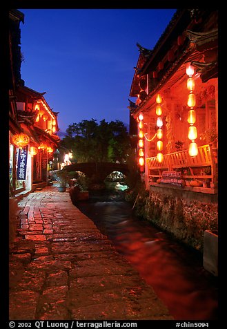 Cobblestone street and canal at night. Lijiang, Yunnan, China (color)