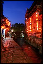 Cobblestone street and canal at night. Lijiang, Yunnan, China (color)