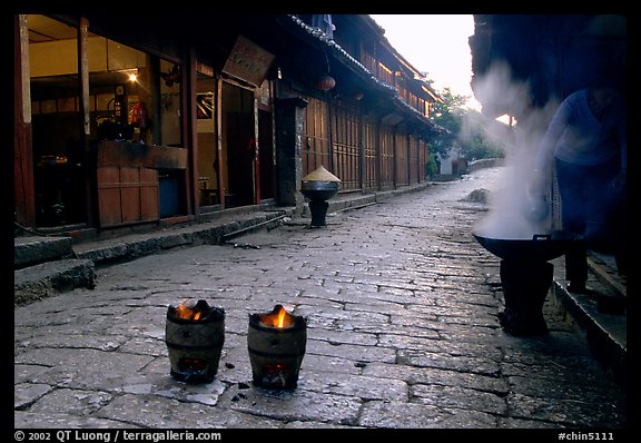 Dumplings being cooked in a cobblestone street. Lijiang, Yunnan, China (color)