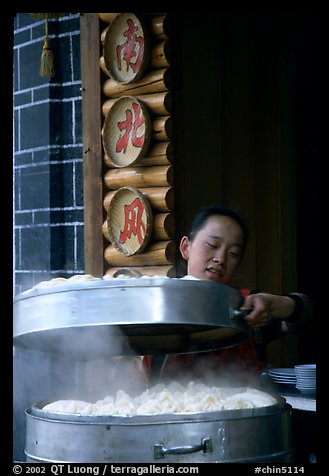 Woman baking dumplings. Lijiang, Yunnan, China (color)