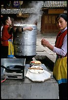Naxi Woman preparing the baba flatbreat. Lijiang, Yunnan, China (color)