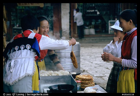 Naxi Women preparing the baba flatbreat. Lijiang, Yunnan, China