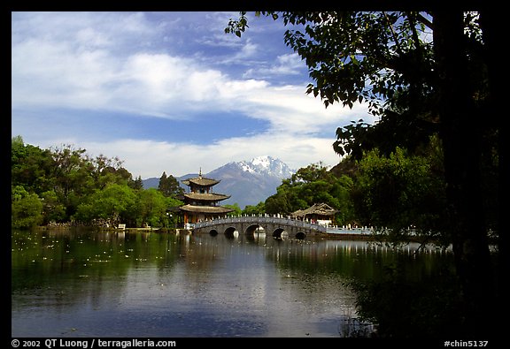 Pavillon reflected in the Black Dragon Pool, with Jade Dragon Snow Mountains in the background. Lijiang, Yunnan, China (color)
