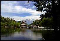 Pavillon reflected in the Black Dragon Pool, with Jade Dragon Snow Mountains in the background. Lijiang, Yunnan, China