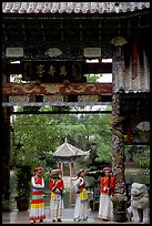 Women in Naxi dress standing in an archway. Lijiang, Yunnan, China (color)