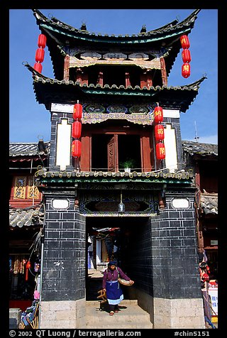 Woman under the Kegong tower archway. Lijiang, Yunnan, China