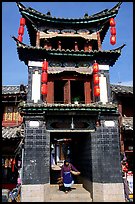 Woman under the Kegong tower archway. Lijiang, Yunnan, China