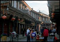 Schoolchildren get Naxi flatbread for breakfast, Jade Dragon Snow Mountain in the background. Lijiang, Yunnan, China